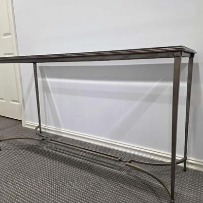 Sale Photo Thumbnail #182: Modern silver iron and glass sofa/entry table in excellent condition. The glass top is clean and clear without scratches. It measures 56"L x 20"D x 30"H.