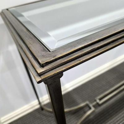 Sale Photo Thumbnail #186: Modern silver iron and glass sofa/entry table in excellent condition. The glass top is clean and clear without scratches. It measures 56"L x 20"D x 30"H.