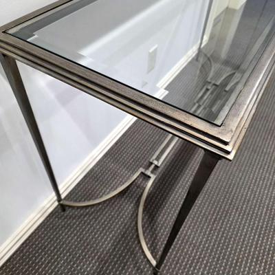 Sale Photo Thumbnail #187: Modern silver iron and glass sofa/entry table in excellent condition. The glass top is clean and clear without scratches. It measures 56"L x 20"D x 30"H.
