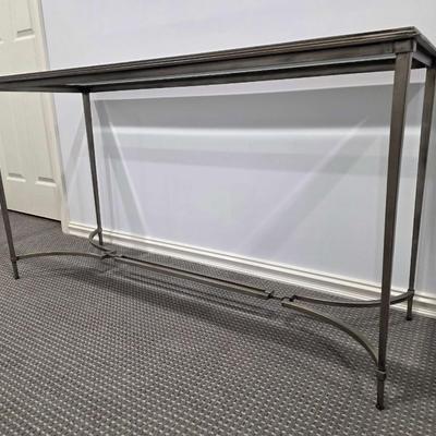 Sale Photo Thumbnail #181: Modern silver iron and glass sofa/entry table in excellent condition. The glass top is clean and clear without scratches. It measures 56"L x 20"D x 30"H.