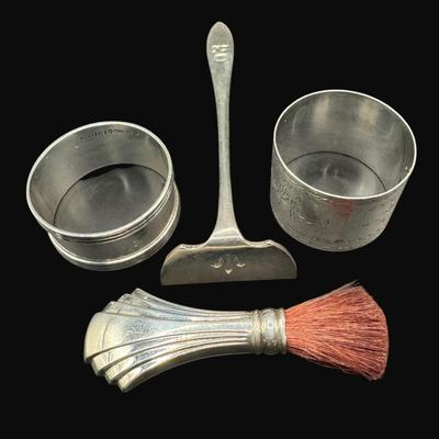 Sale Photo Thumbnail #488: **WIRE TRANSFER IS REQUIRED IF SHIPPED.** [106.95g] Includes a vanity brush, two napkin rings, and a crumb scraper. Silver content confirmed using Niton XRF precious metals analyzer. Weight is overall, and includes non-silver components. **ALL PRECIOUS ME