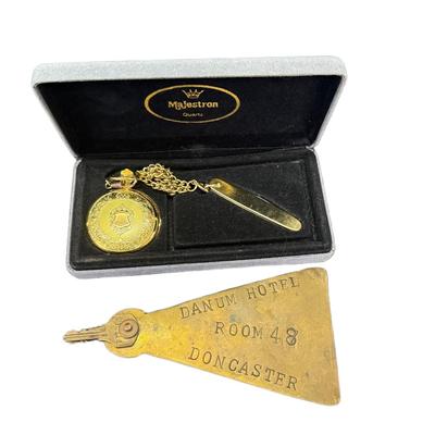 Sale Photo Thumbnail #516: Includes a Majestron pocket watch/knife combo, and a brass Danum hotel key from Doncaster. Total of two pieces. Watch not tested. [RM]