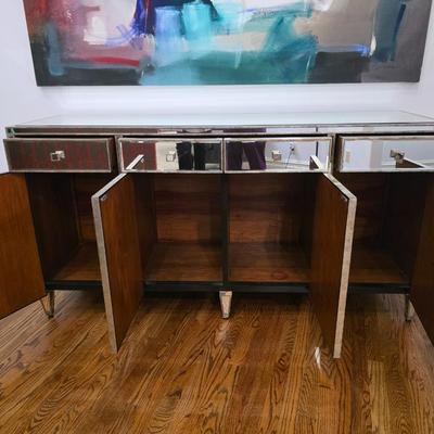 Sale Photo Thumbnail #201: This elegant, mirrored buffet/credenza cabinet is stunning and functional with lots of storage space. It measures 67"L x 34.5" H x 20"D. The cabinet is the only item you're bidding on, any other furniture or art you see in the photograph is NOT included.