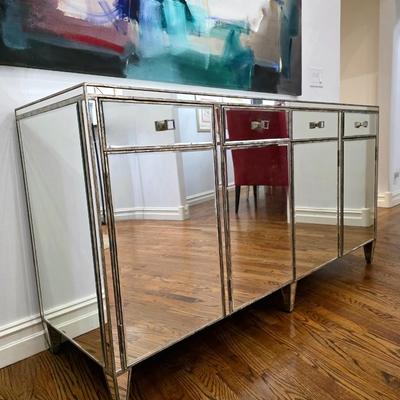 Sale Photo Thumbnail #197: This elegant, mirrored buffet/credenza cabinet is stunning and functional with lots of storage space. It measures 67"L x 34.5" H x 20"D. The cabinet is the only item you're bidding on, any other furniture or art you see in the photograph is NOT included.