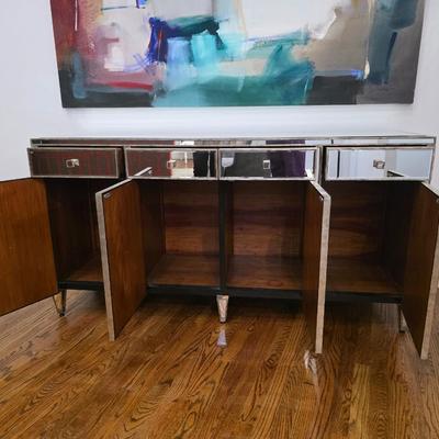 Sale Photo Thumbnail #200: This elegant, mirrored buffet/credenza cabinet is stunning and functional with lots of storage space. It measures 67"L x 34.5" H x 20"D. The cabinet is the only item you're bidding on, any other furniture or art you see in the photograph is NOT included.