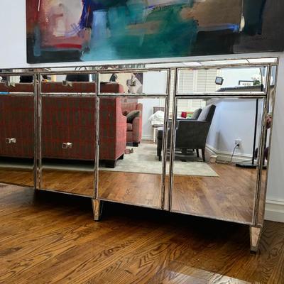 Sale Photo Thumbnail #196: This elegant, mirrored buffet/credenza cabinet is stunning and functional with lots of storage space. It measures 67"L x 34.5" H x 20"D. The cabinet is the only item you're bidding on, any other furniture or art you see in the photograph is NOT included.