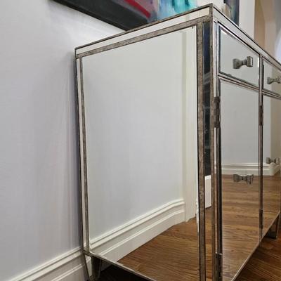 Sale Photo Thumbnail #198: This elegant, mirrored buffet/credenza cabinet is stunning and functional with lots of storage space. It measures 67"L x 34.5" H x 20"D. The cabinet is the only item you're bidding on, any other furniture or art you see in the photograph is NOT included.