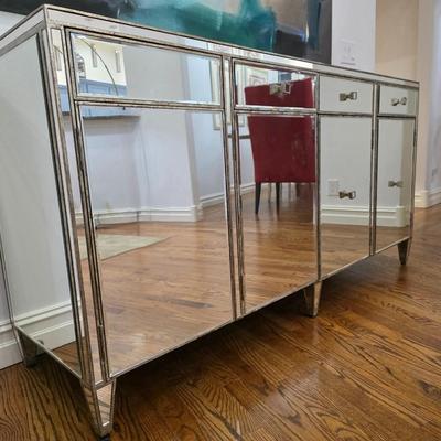 Sale Photo Thumbnail #195: This elegant, mirrored buffet/credenza cabinet is stunning and functional with lots of storage space. It measures 67"L x 34.5" H x 20"D. The cabinet is the only item you're bidding on, any other furniture or art you see in the photograph is NOT included.