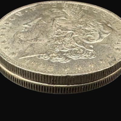 Sale Photo Thumbnail #592: **WIRE TRANSFER IS REQUIRED IF SHIPPED.** Includes an 1885-O (New Orleans), and a 1921 Philadelphia. Both are believed to be almost uncirculated. Silver content is 90%, **ALL PRECIOUS METALS SALES ARE FINAL. NO REFUNDS WILL BE GIVEN FOR ANY REASON.** [AG]