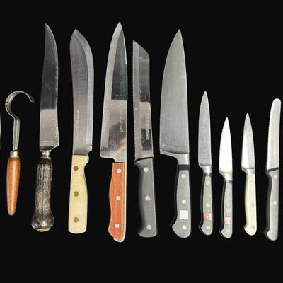 Sale Photo Thumbnail #612: Includes Wustof, Henckels, Eversharp, Maxam Steel, Universal, and Old Homestead. Total of 13 pieces. Measurement of longest: 13”. [CS]