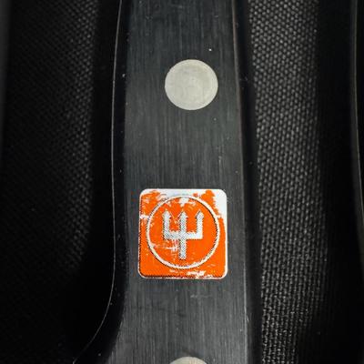 Sale Photo Thumbnail #614: Includes Wustof, Henckels, Eversharp, Maxam Steel, Universal, and Old Homestead. Total of 13 pieces. Measurement of longest: 13”. [CS]