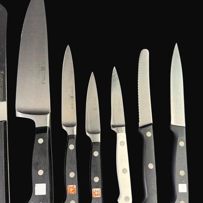 Sale Photo Thumbnail #613: Includes Wustof, Henckels, Eversharp, Maxam Steel, Universal, and Old Homestead. Total of 13 pieces. Measurement of longest: 13”. [CS]