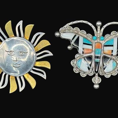Sale Photo Thumbnail #623: **WIRE TRANSFER IS REQUIRED IF SHIPPED.** [32.25g] Includes a Taxco marked sunshine pin with gold vermeil accents, and a turquoise, onyx, moonstone, and coral butterfly pin. Total of two pieces. Measurement of largest: 2.25”. Silver content confirmed us