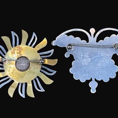 Sale Photo Thumbnail #624: **WIRE TRANSFER IS REQUIRED IF SHIPPED.** [32.25g] Includes a Taxco marked sunshine pin with gold vermeil accents, and a turquoise, onyx, moonstone, and coral butterfly pin. Total of two pieces. Measurement of largest: 2.25”. Silver content confirmed us