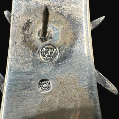 Sale Photo Thumbnail #631: **WIRE TRANSFER IS REQUIRED IF SHIPPED.** [25.92g] Includes a Danish ship design pin, a Far Fetched Co. pin with gold vermeil, and an Arabic sword pin. Total of three pieces. There is age related wear to the sword pin. Measurement of largest: 2.5”. Silv