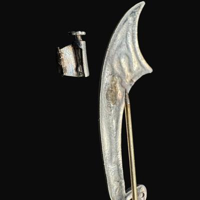 Sale Photo Thumbnail #632: **WIRE TRANSFER IS REQUIRED IF SHIPPED.** [25.92g] Includes a Danish ship design pin, a Far Fetched Co. pin with gold vermeil, and an Arabic sword pin. Total of three pieces. There is age related wear to the sword pin. Measurement of largest: 2.5”. Silv