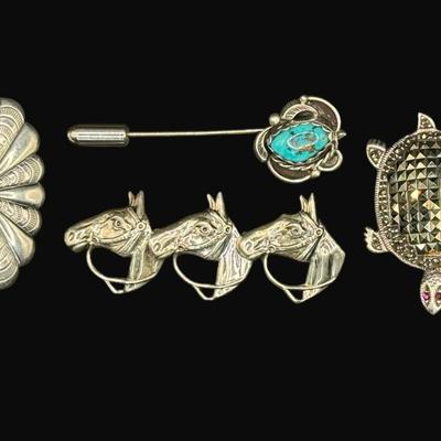 Sale Photo Thumbnail #633: **WIRE TRANSFER IS REQUIRED IF SHIPPED.** [26.57g] Includes a turquoise cabochon stick pin, a marcasite turtle, a horse head pin, and a bell pin. The horse head pin is marked “Beau Navajo.” Total of four pieces. Measurement of largest: 2.25”. Silver