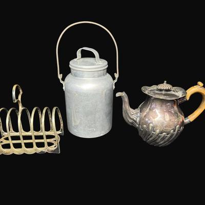 Sale Photo Thumbnail #666: Includes a vintage English toast rack, a vintage Wear-Ever aluminum milk jug, and an antique English tea pot. Total of three pieces. Measurement of tallest: 8.5”H. [CS]