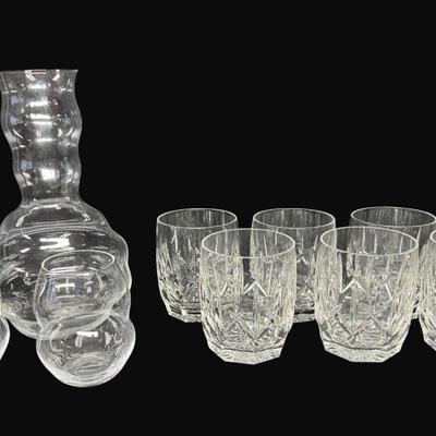Sale Photo Thumbnail #669: Includes seven Waterford Westhampton double glasses, and a Reidel swirl crystal wire decanter with two matching wine glasses. Total of ten pieces. Measurement of largest: 9.5”H. [CS]