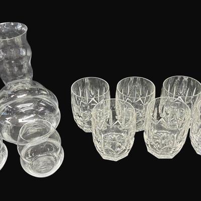 Sale Photo Thumbnail #670: Includes seven Waterford Westhampton double glasses, and a Reidel swirl crystal wire decanter with two matching wine glasses. Total of ten pieces. Measurement of largest: 9.5”H. [CS]