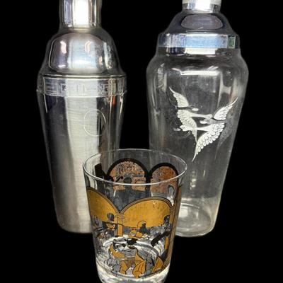 Sale Photo Thumbnail #689: Includes a Hirschfield glass “Broadway Stars,” a Rockwell Silver Co. shaker, and a stainless steel recipe cocktail shaker. Total of three pieces. Measurement of tallest: 11”. [CS]
