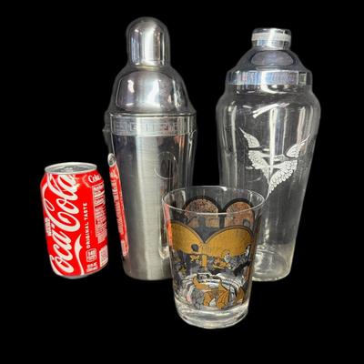 Sale Photo Thumbnail #690: Includes a Hirschfield glass “Broadway Stars,” a Rockwell Silver Co. shaker, and a stainless steel recipe cocktail shaker. Total of three pieces. Measurement of tallest: 11”. [CS]