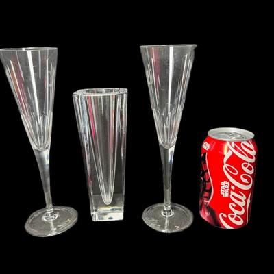 Sale Photo Thumbnail #694: Includes a pair of Tiffany & Co. toasting flutes, and an Orrefors Odyssey square vase. Total of three pieces. Measurement of largest: 9”H. [CS]