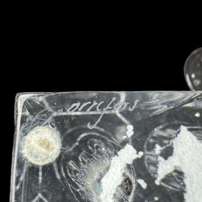 Sale Photo Thumbnail #696: Includes a pair of Tiffany & Co. toasting flutes, and an Orrefors Odyssey square vase. Total of three pieces. Measurement of largest: 9”H. [CS]