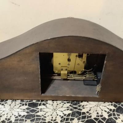 Sale Photo Thumbnail #188: This isa wood mantle clock. Has the key to wind it, but is missing clock hands and back door.