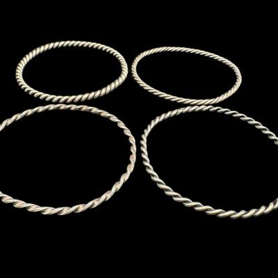 Sale Photo Thumbnail #698: **WIRE TRANSFER IS REQUIRED IF SHIPPED.** [43.04g] Includes four twisted sterling silver bangles. Each is approximately 2.75” in diameter. Silver content confirmed using Niton XRF precious metals analyzer. **ALL PRECIOUS METALS SALES ARE FINAL. NO REFUN