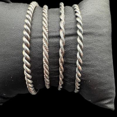 Sale Photo Thumbnail #697: **WIRE TRANSFER IS REQUIRED IF SHIPPED.** [43.04g] Includes four twisted sterling silver bangles. Each is approximately 2.75” in diameter. Silver content confirmed using Niton XRF precious metals analyzer. **ALL PRECIOUS METALS SALES ARE FINAL. NO REFUN