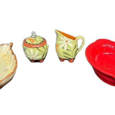 Sale Photo Thumbnail #714: Includes a Nancy Gardner hand built cream and sugar, a vintage Frankoma leaf bowl, and an individual modern Fiesta casserole. Total of four pieces. Measurement of largest: 9”. [CS]