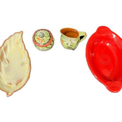 Sale Photo Thumbnail #715: Includes a Nancy Gardner hand built cream and sugar, a vintage Frankoma leaf bowl, and an individual modern Fiesta casserole. Total of four pieces. Measurement of largest: 9”. [CS]