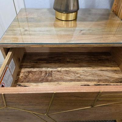 Sale Photo Thumbnail #252: West Elm Nightstand #1. Modern wood with geometric brass accent. Measures 24"W x 24"H. There are 2 exact nightstands available. You are only bidding on one here. Please see item 37KBMN to bid on nightstand #2.