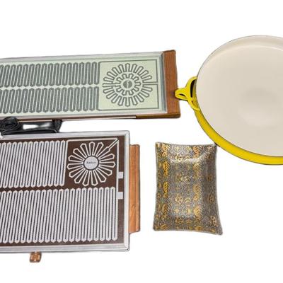 Sale Photo Thumbnail #744: Includes a Dansk paella pan, two Salton Hotray food warmers (one cord), and a George Briard bent glass plate dish. Not tested. Age related wear. Measurement of largest: 25”L. [CS]