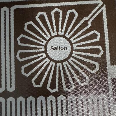 Sale Photo Thumbnail #745: Includes a Dansk paella pan, two Salton Hotray food warmers (one cord), and a George Briard bent glass plate dish. Not tested. Age related wear. Measurement of largest: 25”L. [CS]