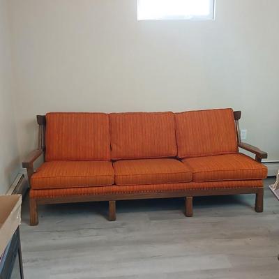 Vintage A. Brandt Ranch Oak sofa with original orange textured fabric cushions.