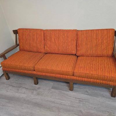 Vintage A. Brandt Ranch Oak sofa with original orange textured fabric cushions.