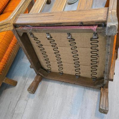 A. Brandt Ranch Oak lounge chair with orange upholstery.