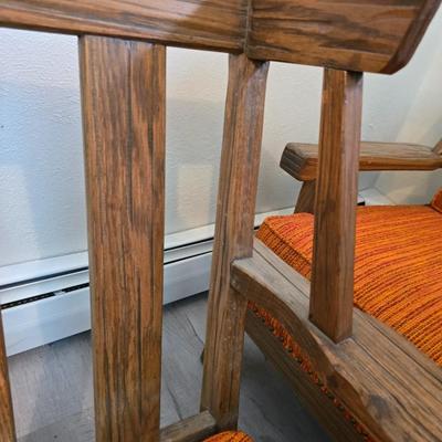 A. Brandt Ranch Oak lounge chair with orange upholstery.