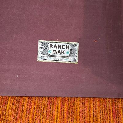 A. Brandt Ranch Oak lounge chair with orange upholstery.