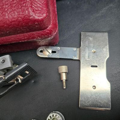 Singer button holder with large fabric scraps and vintage needles