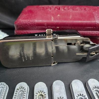 Singer button holder with large fabric scraps and vintage needles