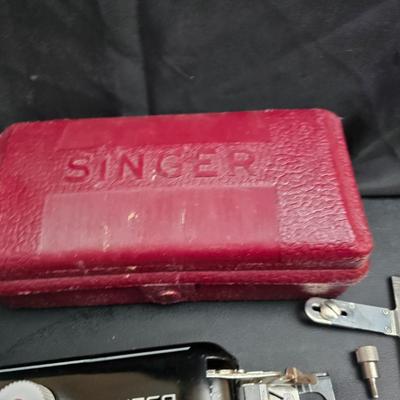 Singer button holder with large fabric scraps and vintage needles