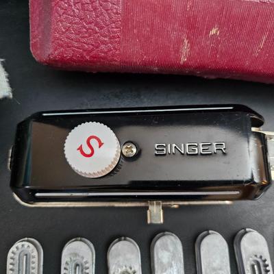 Singer button holder with large fabric scraps and vintage needles