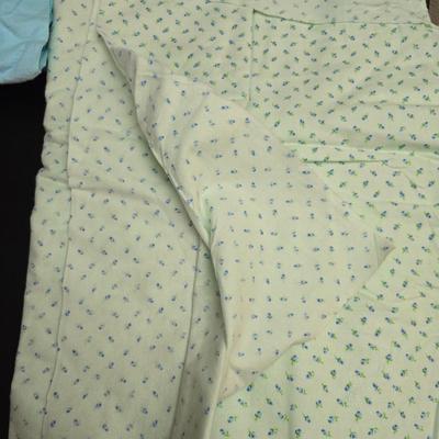 Singer button holder with large fabric scraps and vintage needles