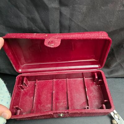 Singer button holder with large fabric scraps and vintage needles