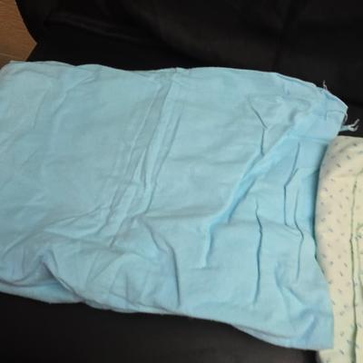 Singer button holder with large fabric scraps and vintage needles