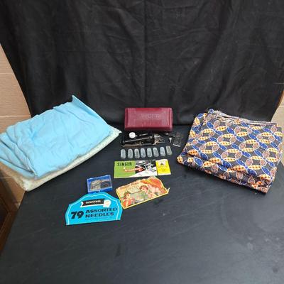 Singer button holder with large fabric scraps and vintage needles