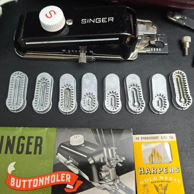 Singer button holder with large fabric scraps and vintage needles